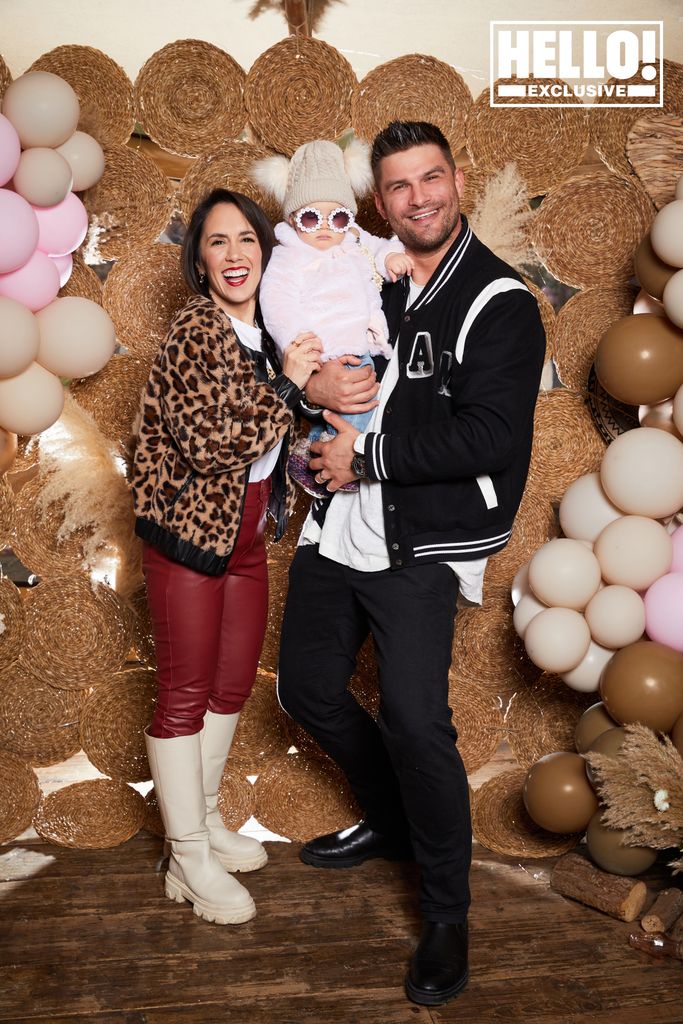 Janette Manrara and Aljaz Skorjanic cuddling baby Lyra in sunglasses