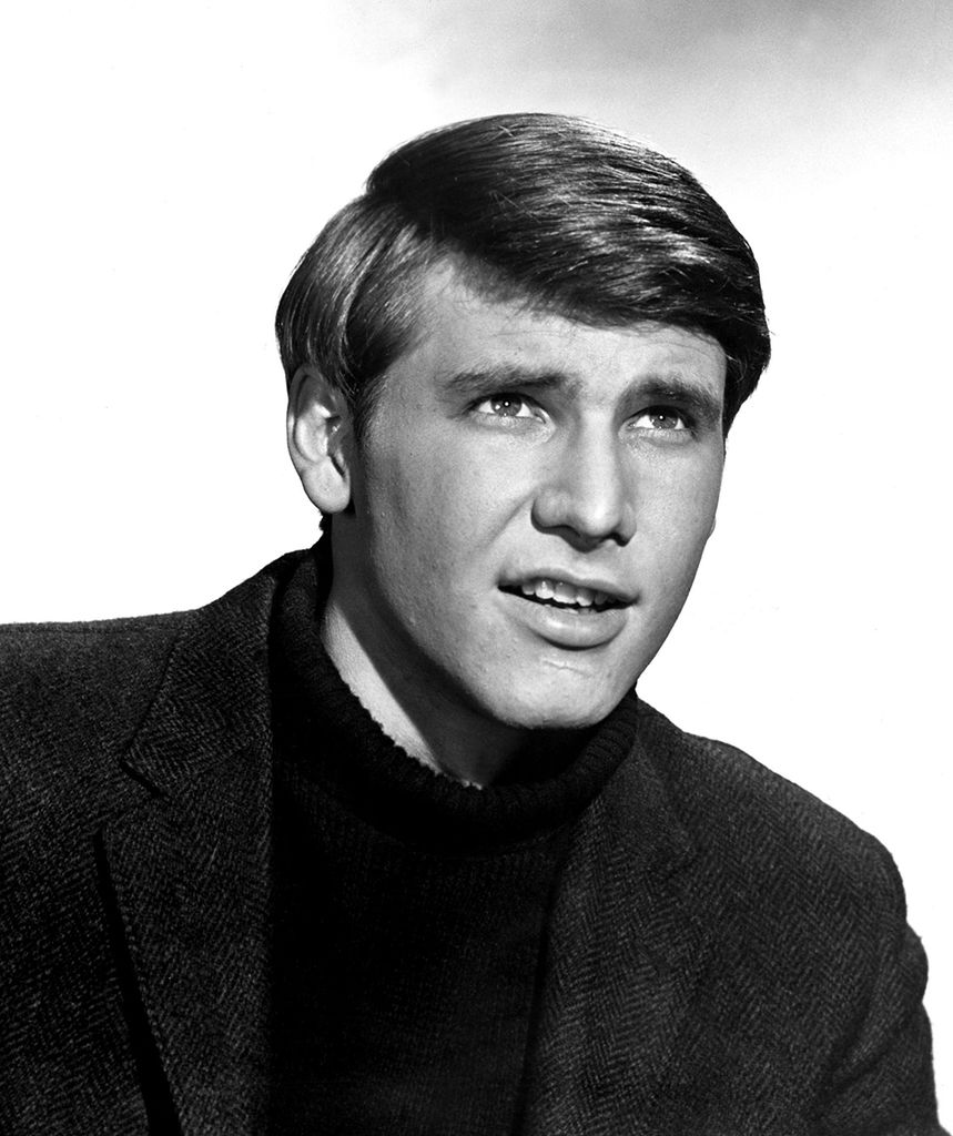 Harrison Ford pictured in 1968. He is 20 years old and wearing a jumper and blazer.