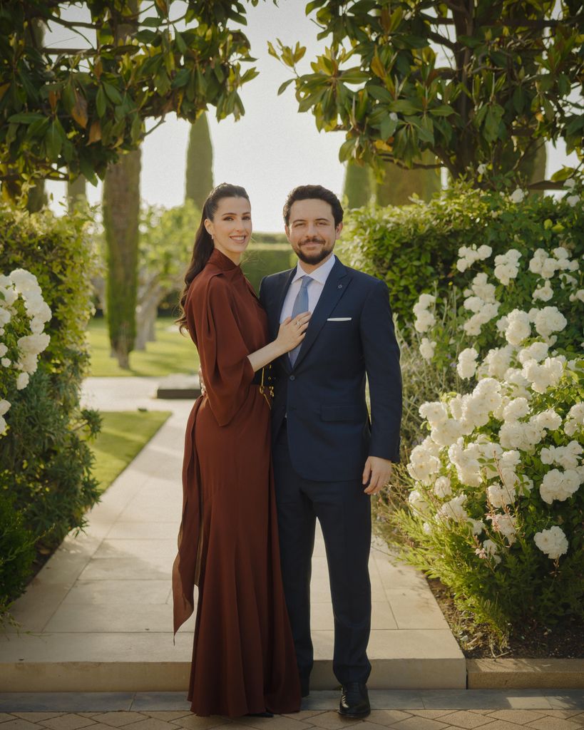 princess rajwa in brown dress with hussein in garden with white flowers