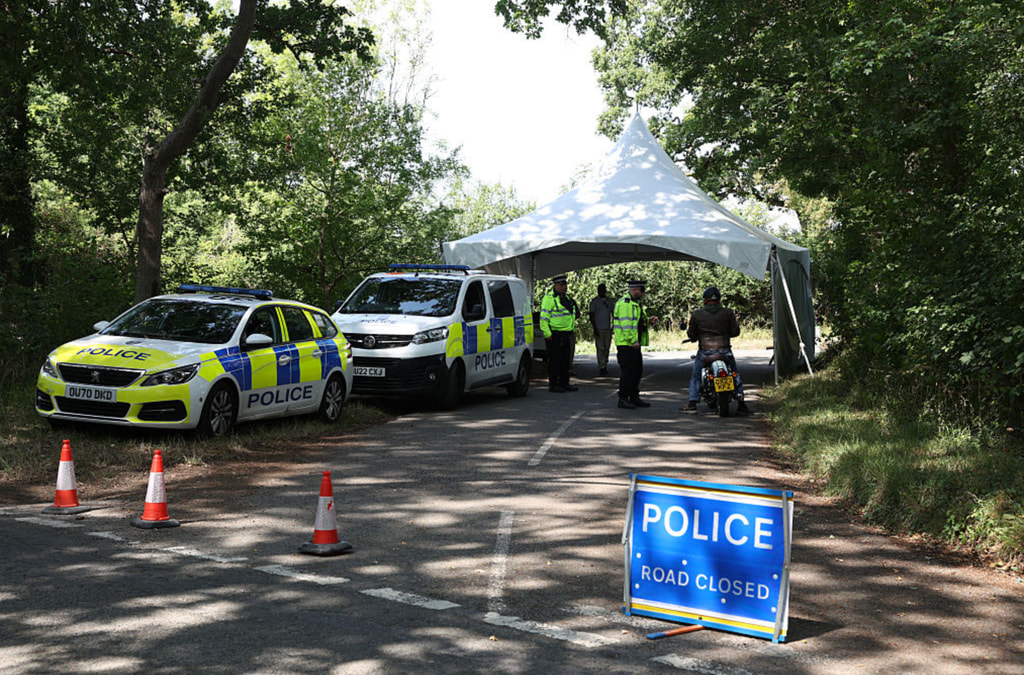 Two police cars and a few police men stationed at the village entrances