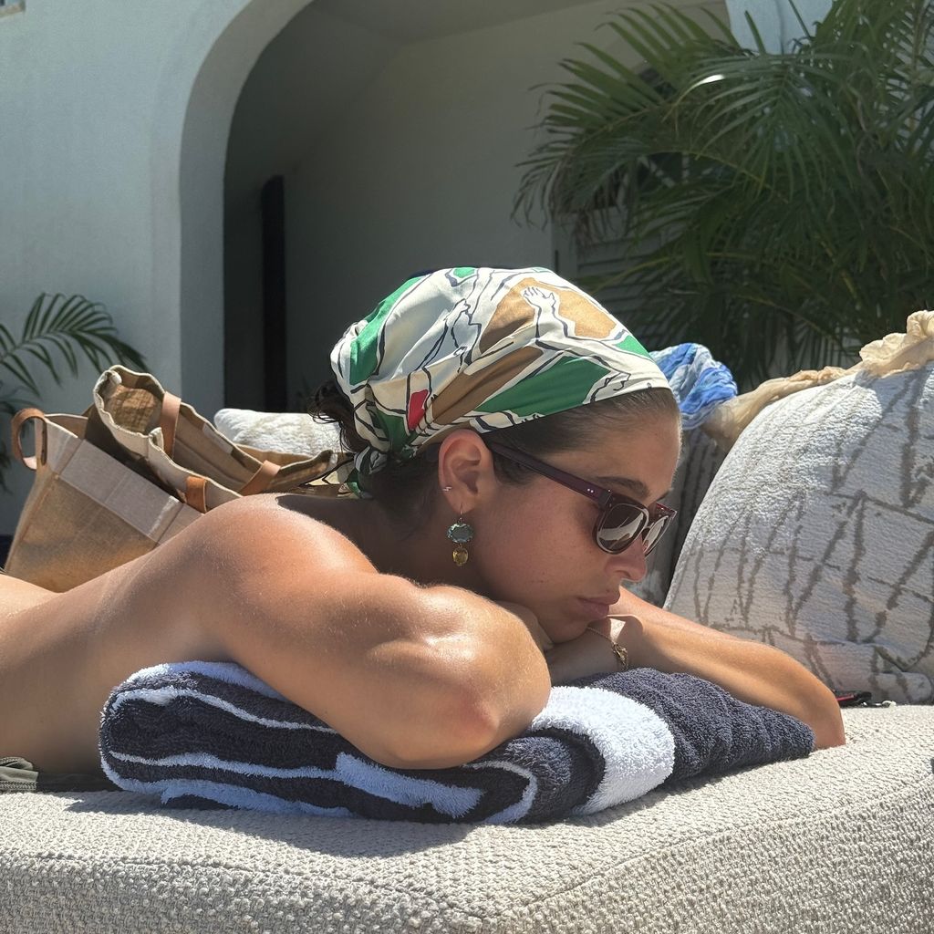 Lola Consuelos sunbathes topless