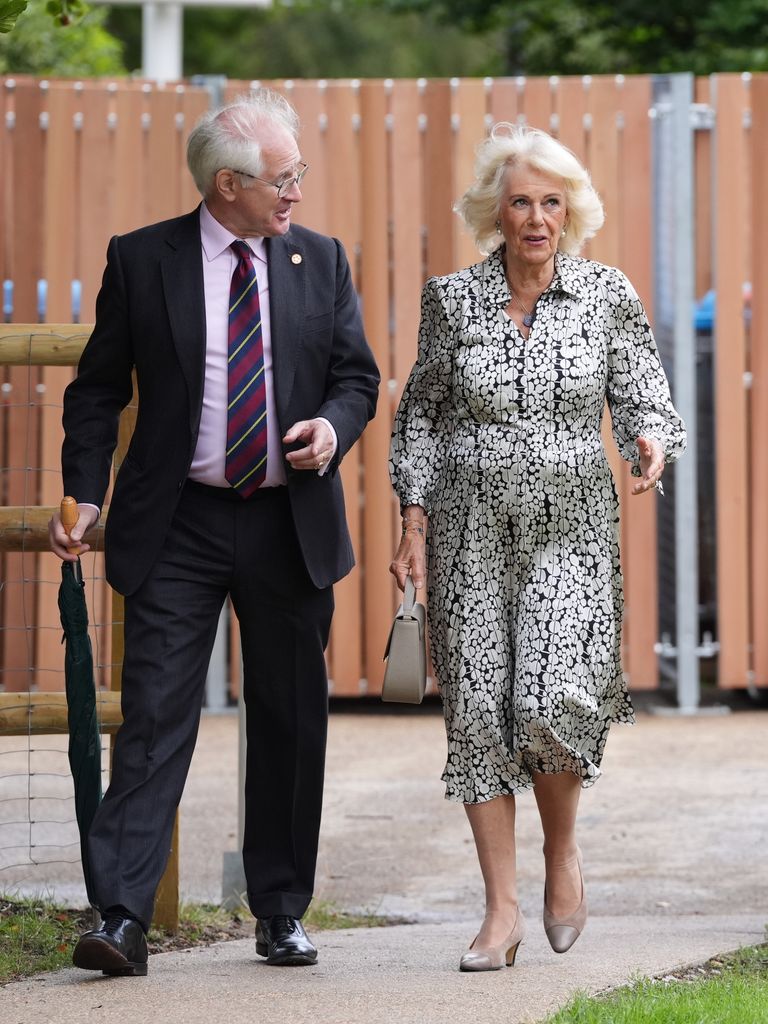 Queen Camilla walking with Simon Duckworth