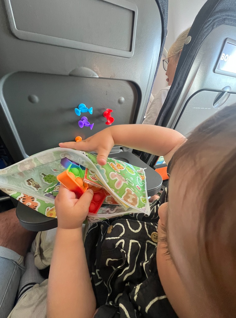 toddler with toys on plane