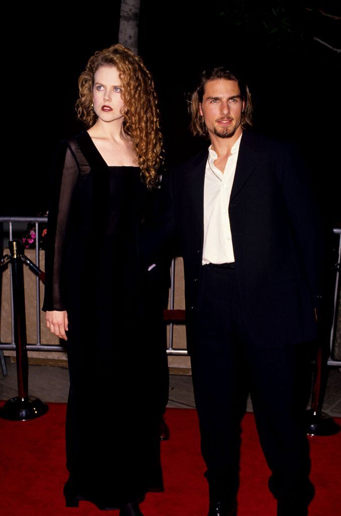 Nicole in black dress with tom cruise on red carpet in 90s
