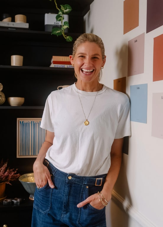 Tash Bradley smiling next to colour samples