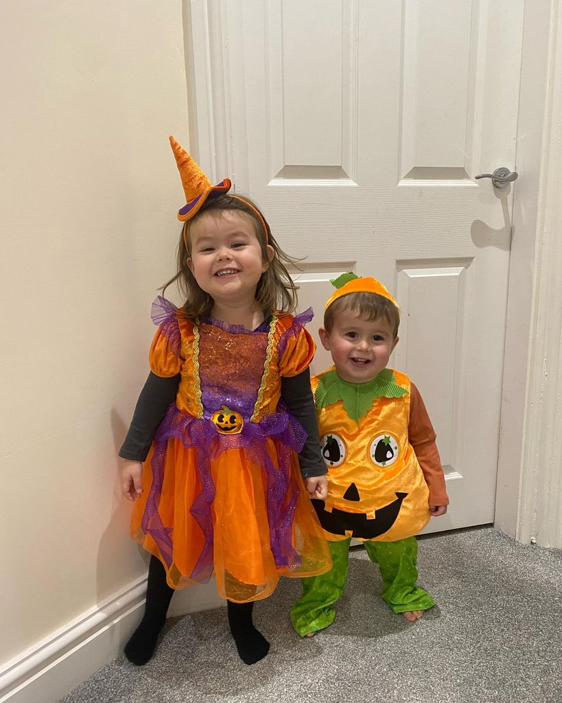 Molly and Zac in pumpkin costumes