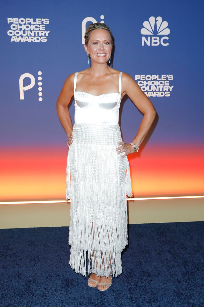 Dylan Dreyer smiling in a white satin tasselled dress