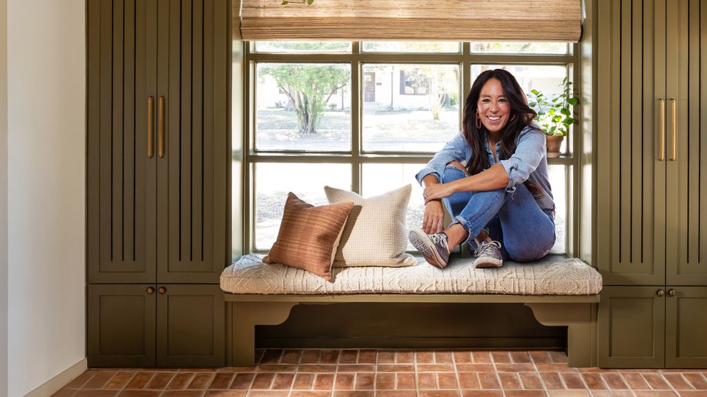 Joanna Gaines sits on a bench in the window