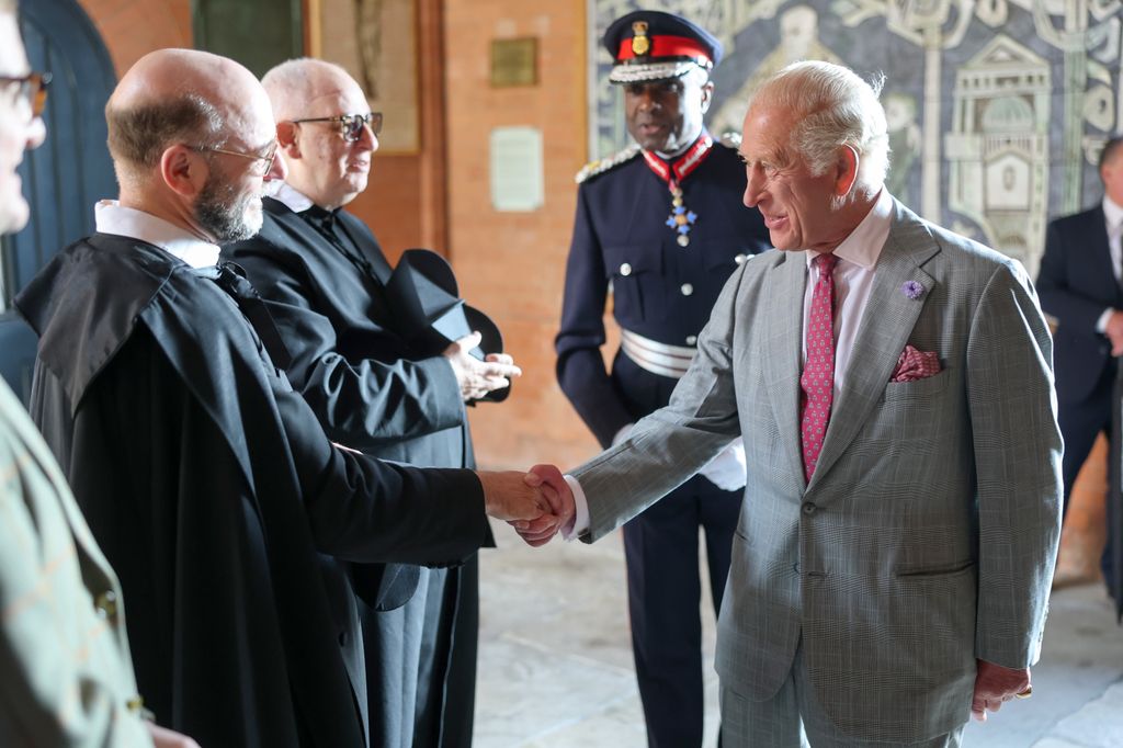 King Charles greets Reverend Anton Guziel as he arrives for a tour of The Oratory of St. Philip Neri