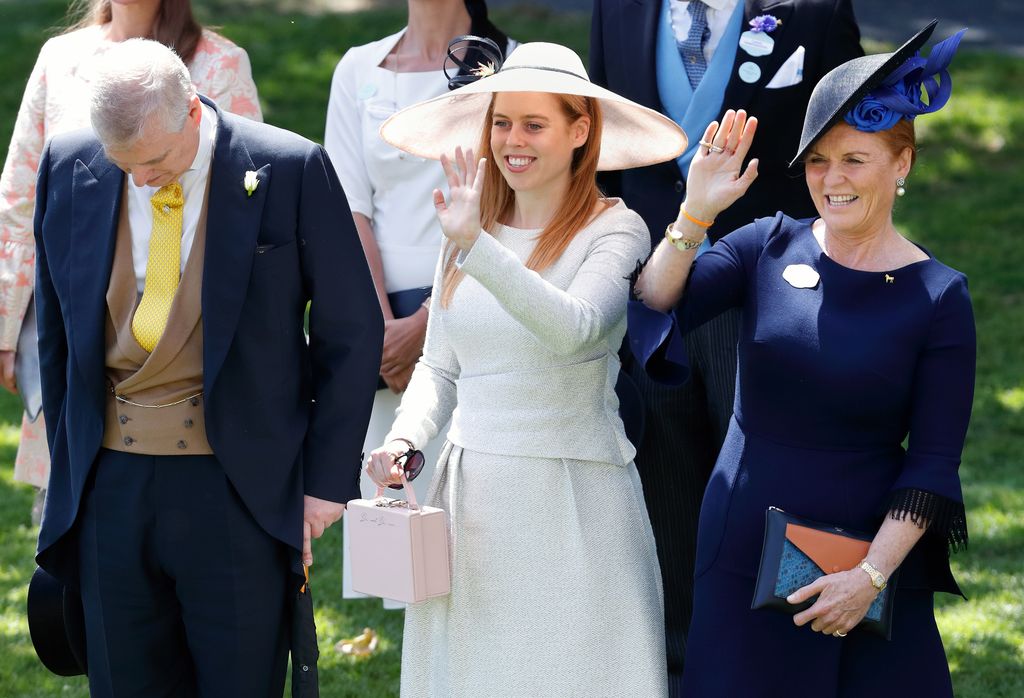 Prince Andrew, Duke of York bows his head whilst Princess Beatrice and Sarah, Duchess of York wave to Queen Elizabeth II as she and her guests pass by in horse drawn carriages on day 4 of Royal Ascot at Ascot Racecourse on June 22, 2018 in Ascot, England