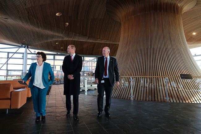 The Prince of Wales walks with Senedd members Elin Jones (L) and David Rees during a visit to the Senedd, the Welsh Parliament, in Cardiff 