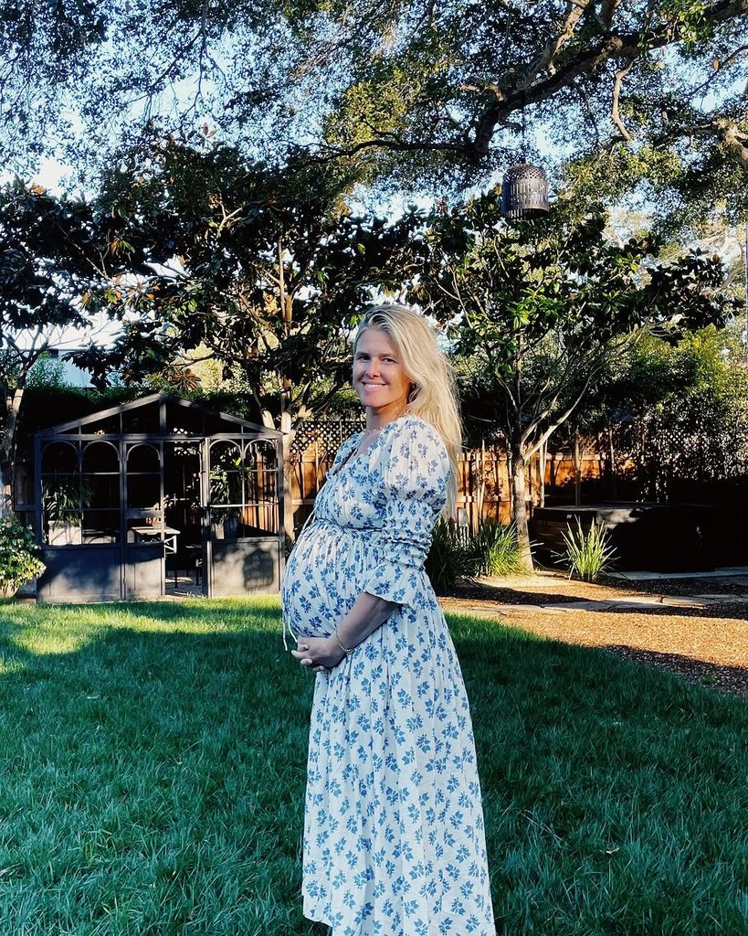 Sarah Wright Olsen poses for a photo cradling her baby bump, shared on Instagram