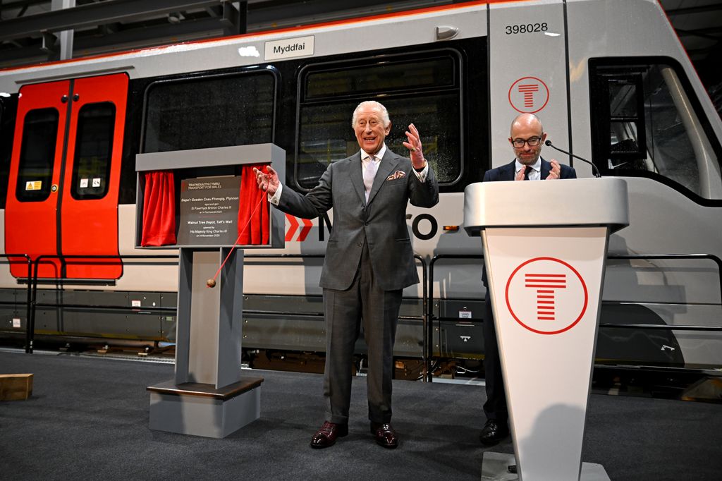 Charles unveils a plaque to commemorate his official opening of the South Wales Metro Depot 