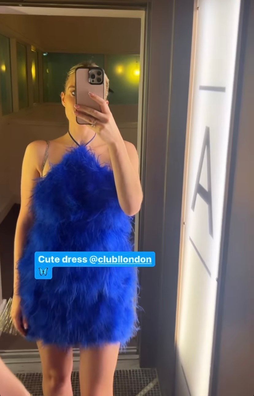 Helen Flanagan posing for a mirror selfie in a blue feathered mini dress