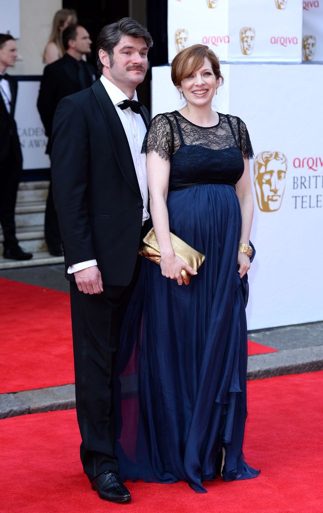 Harry Peacock in a tuxedo and Katherine Parkinson wearing a blue dress