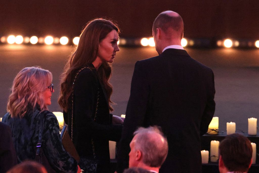 Kate Middleton talking to Prince William in an all-black outfit