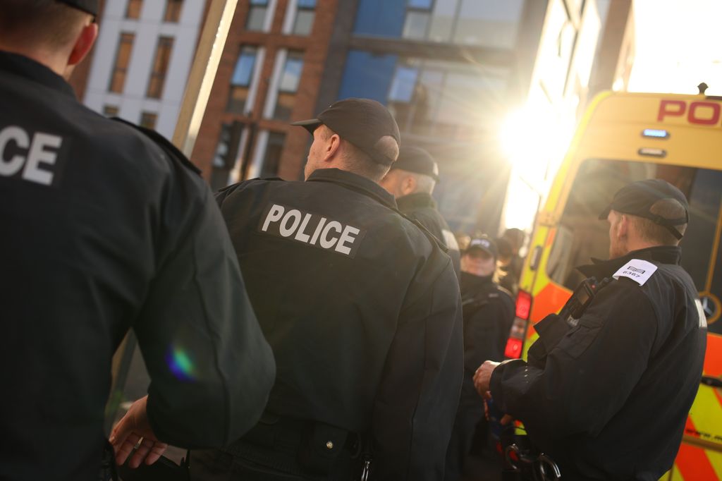 The backs of police officers and a van