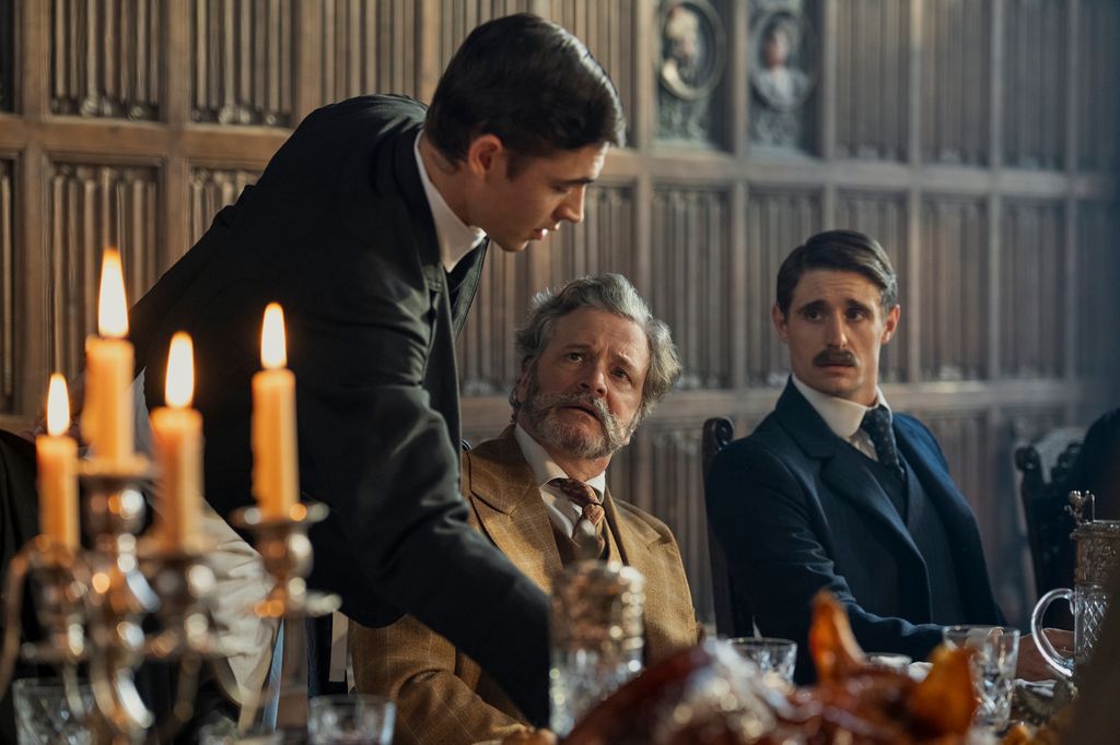 two men in suits sitting at table 