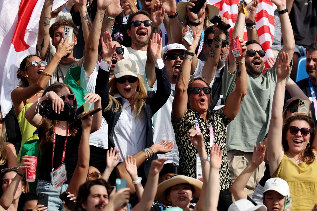 Nicole and her family are seen cheering 