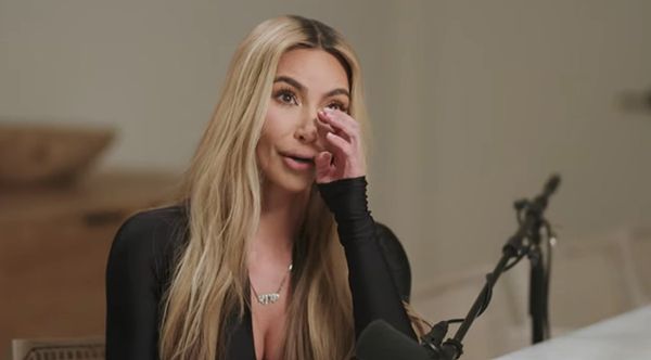 Kim Kardashian wipes away a tear as she delivers emotional interview
