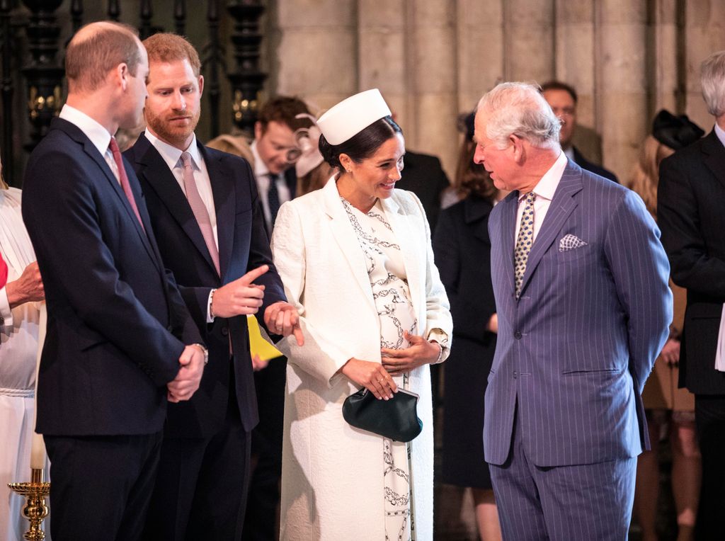 A photo of King Charles and Meghan Markle chatting