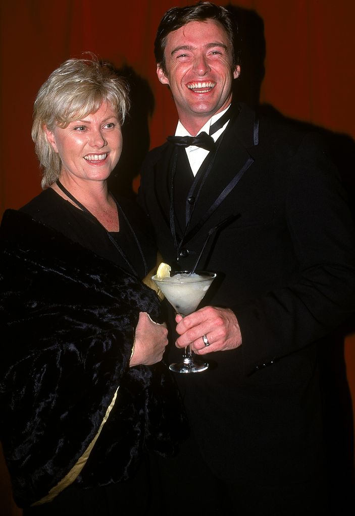 Hugh Jackman holding a martini glass with his wife Deborra-Lee Furness