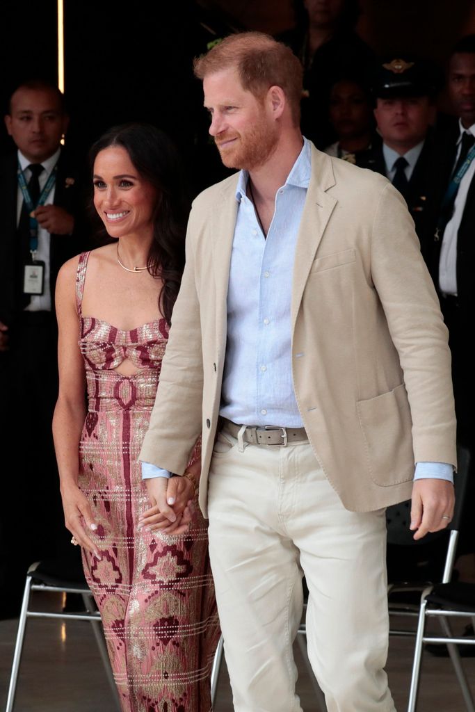 Harry and Meghan hold hands at arts centre