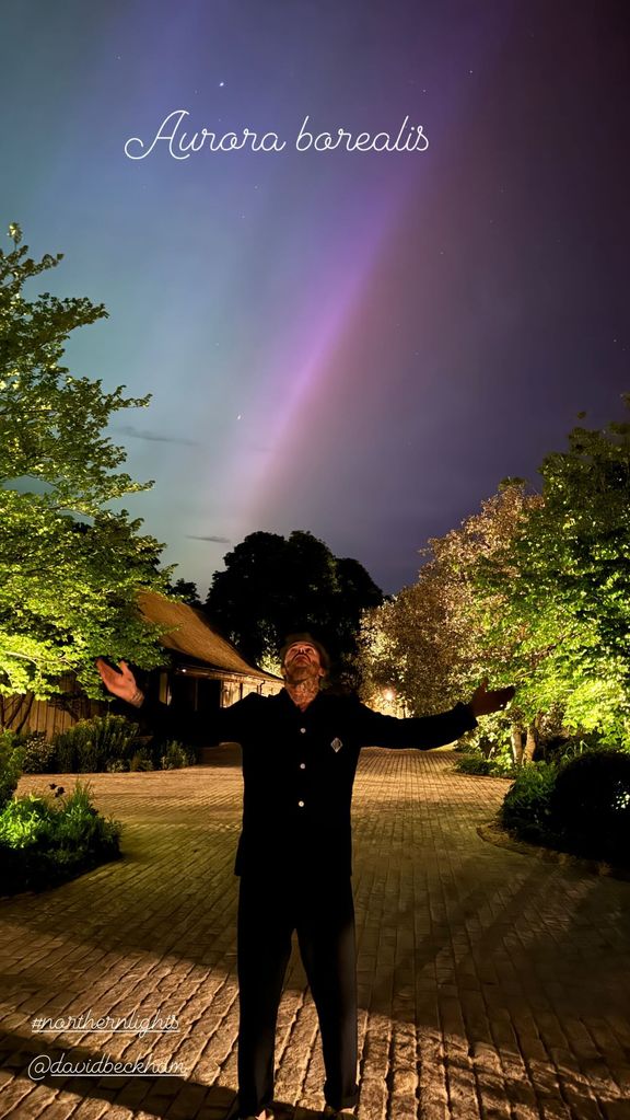 A photo of David Beckham standing under the Northern lights 