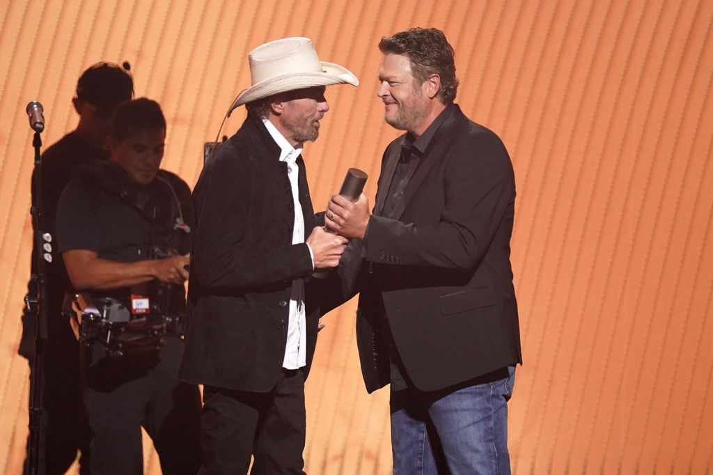 Honoree Toby Keith accepts the Country Icon award from Blake Shelton on stage during the 2023 People's Choice Country Awards