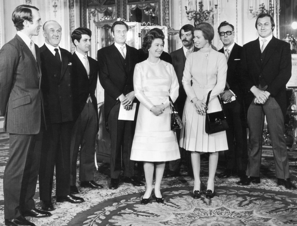 Princess Anne, Captain Mark Phillips and Queen Elizabeth with a group of guests including Inspector James Beaton, journalist Brian McConnell and Detective Constable Peter Edmonds who were all involved with foiling a kidnap attempt on the Princess, 26th November 1974. (Photo by Hulton Archive/Getty Images)