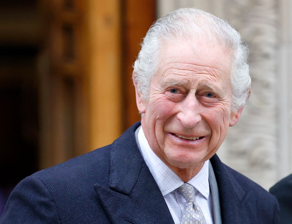 King Charles smiles as he leaves hospital