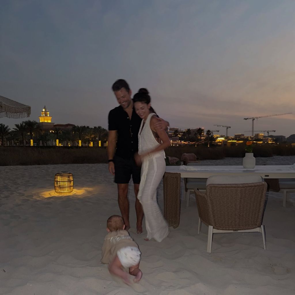 Baby Palma crawling on the beach in Abu Dhabi with mark and michelle watching