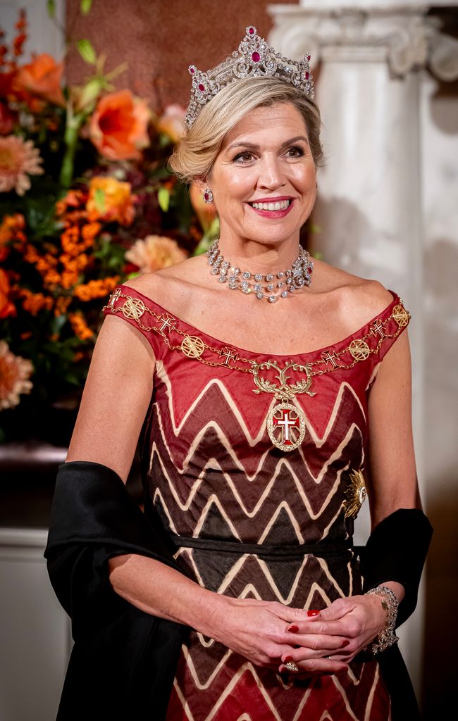 Queen Maxima in red and brown zigzag gown and tiara