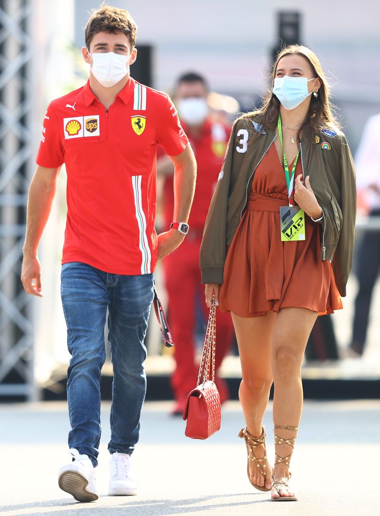 Charles Leclerc and Charlotte Sinus go through the F1 paddock