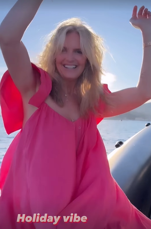 Penny Lancaster in flowing pink dress on holiday