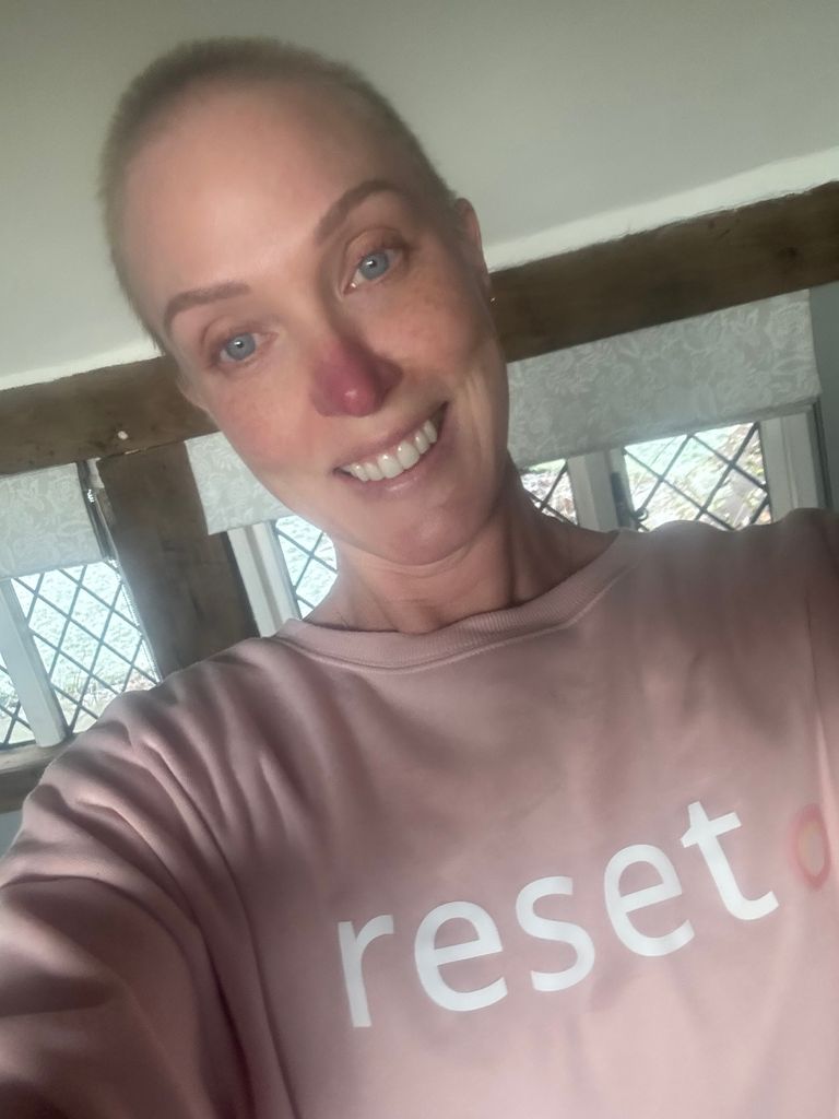 Woman smiling in a pink jumper