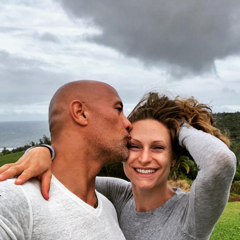 Dwayne with his wife Lauren posing outside 
