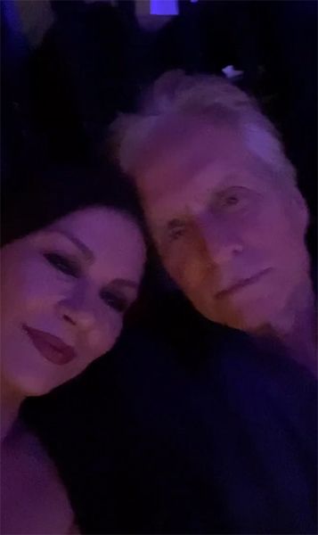 Catherine Zeta Jones and Michael Douglas in low lit restaurant