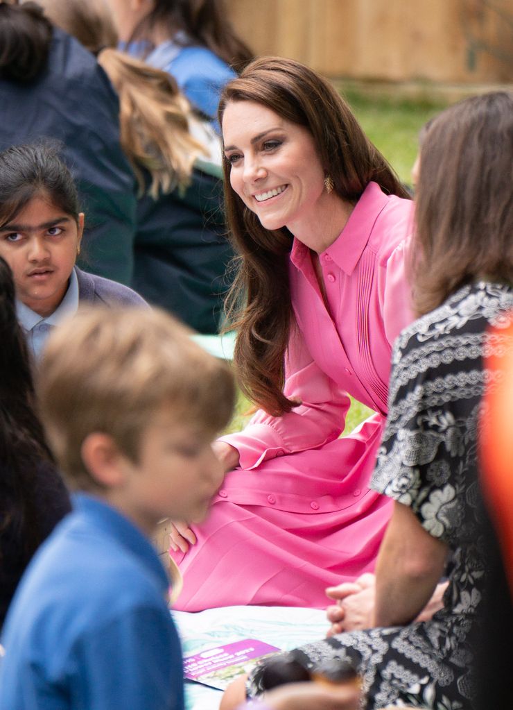 Kate Middleton smiles and talks with school pupils at Chelsea Flower Show