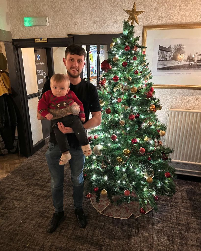 father holding son at christmas time