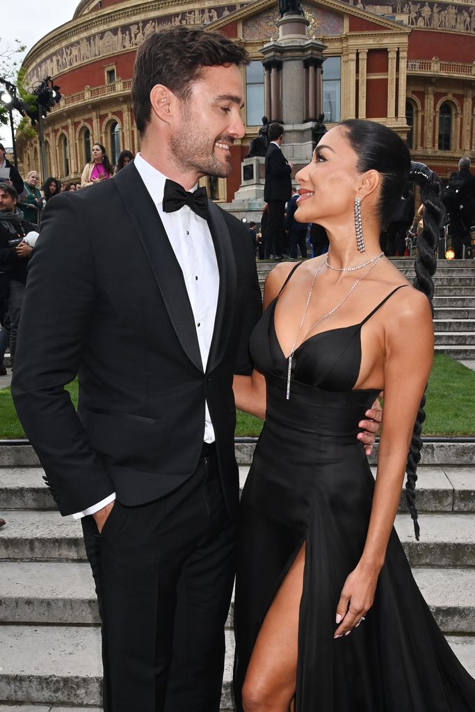 Thom Evans and Nicole Scherzinger look at each other