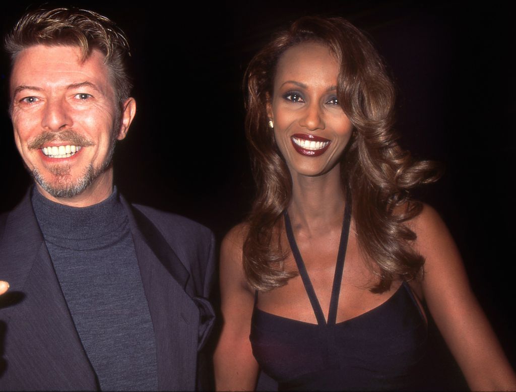 English musician, singer-songwriter, and actor David Bowie and his wife Somali fashion model Iman leaving a theatre on Broadway, New York City, circa 1996. (Photo by Rose Hartman/Archive Photos/Getty Images)
