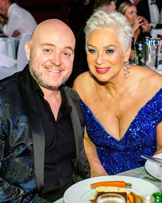 denise welch in a plunging blue dress with her husband Lincoln Townley