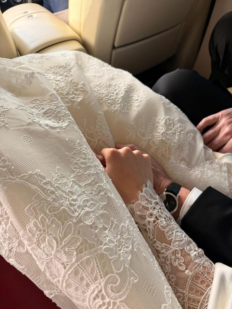 Holly holding hands with father Gordon in the car on the way to her wedding 