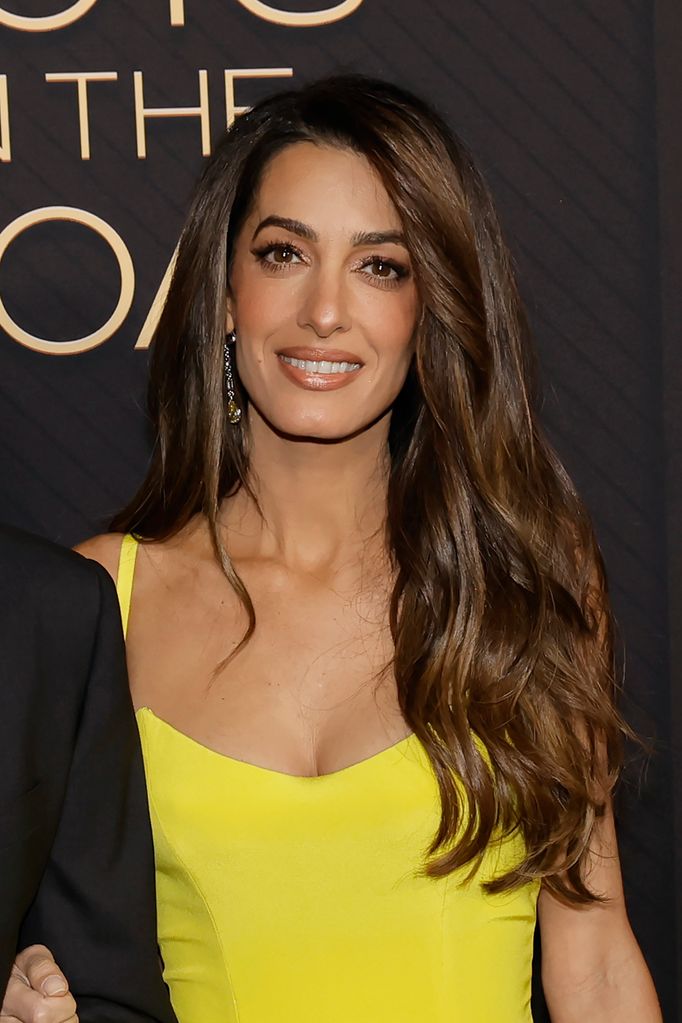 Amal in yellow dress with wavy hair