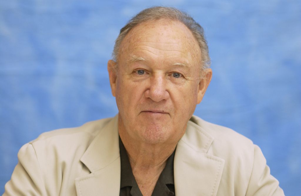 Gene Hackman looking directly at the camera in front of blue screen