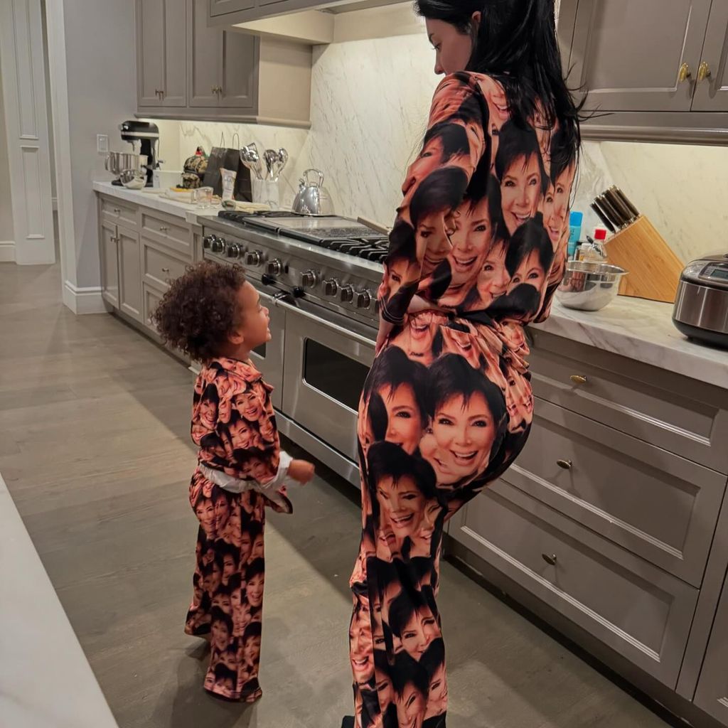 Kylie Jenner wearing pyjamas in her kitchen with her son Aire