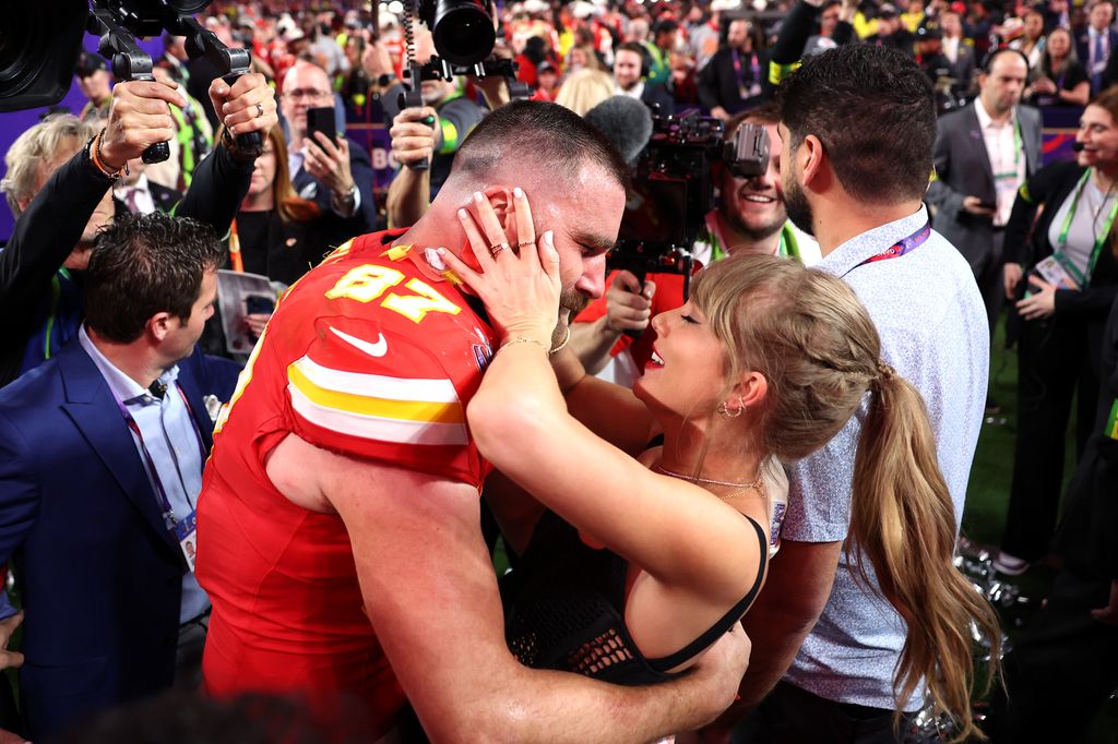Travis Kelce #87 of the Kansas City Chiefs celebrates with Taylor Swift after defeating the San Francisco 