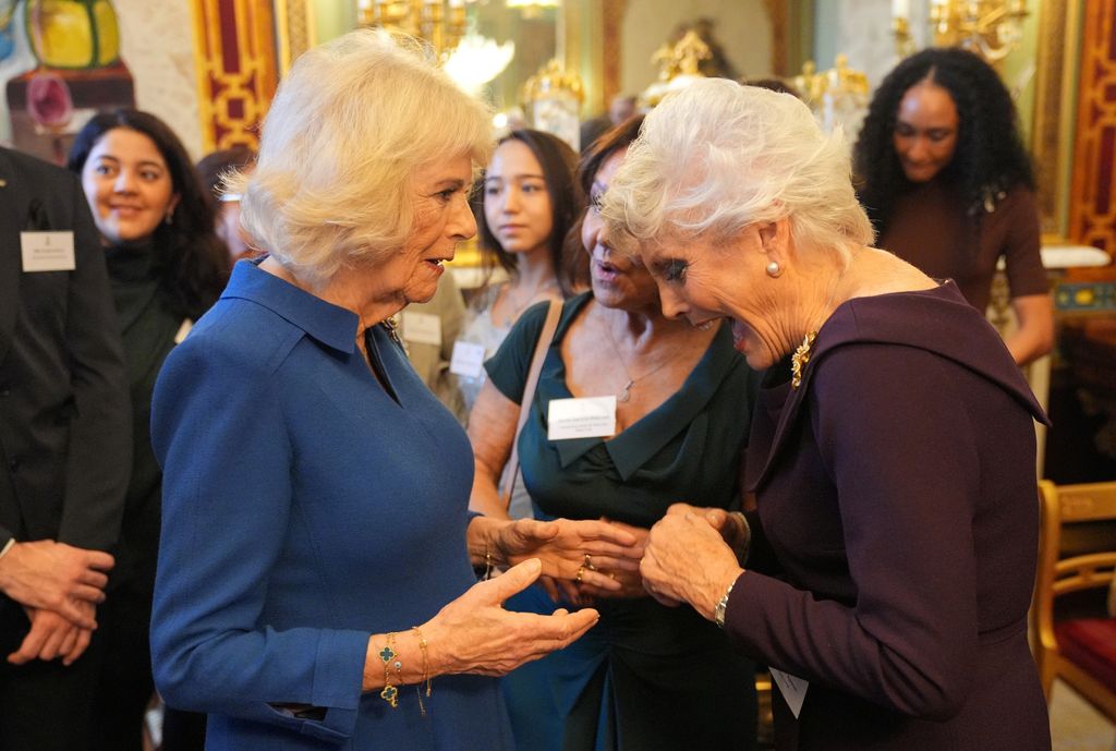 Queen Camilla speaking with Arlene Phillip and Angela Rippon at buckingham palace