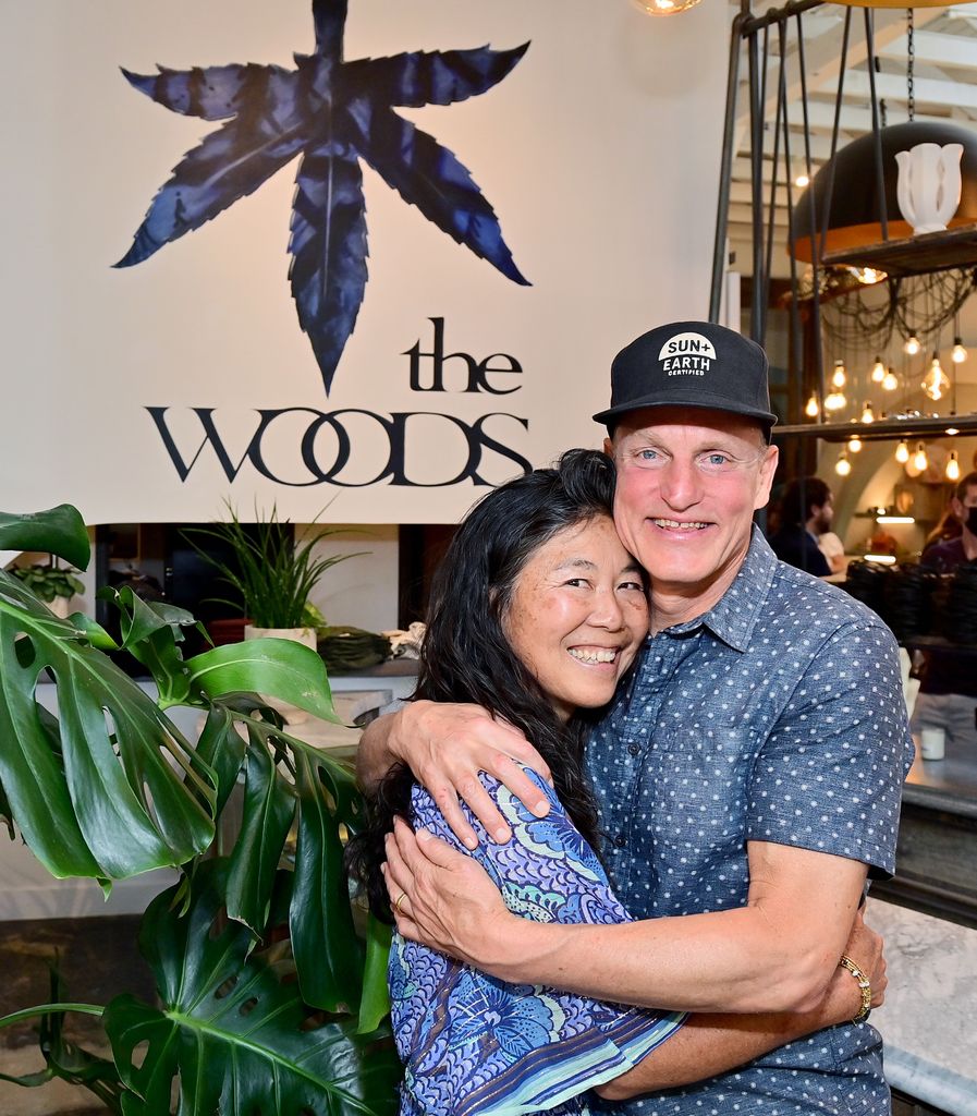 Laura Harrelson in blue dress and Woody Harrelson in blue shirt attend 'The Woods' Opening Day